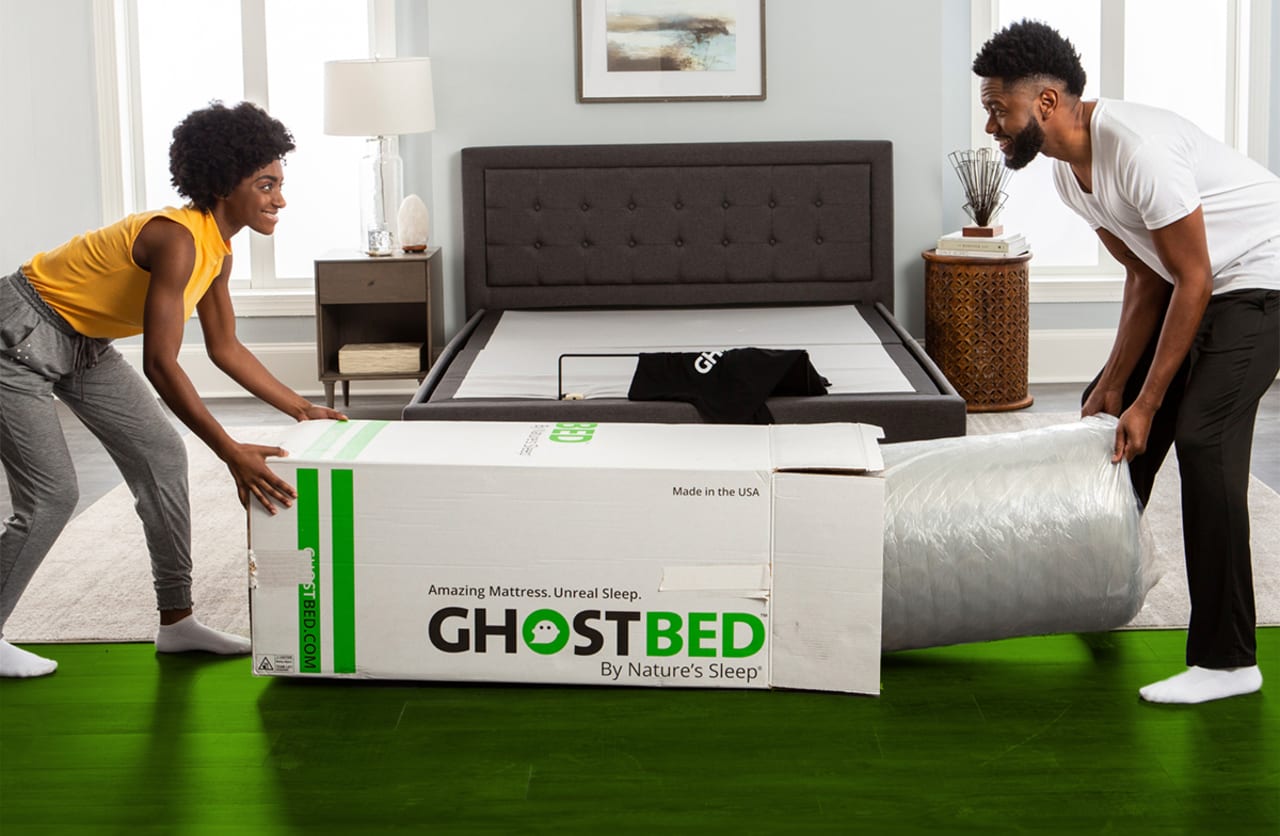 A couple unboxing the GhostBed